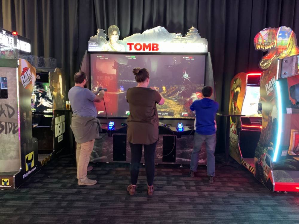 Three alumni playing Tomb